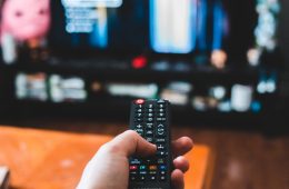 person holding black remote control