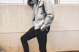 Model in a Gray Jacket and Black Pants Standing on the Stairs