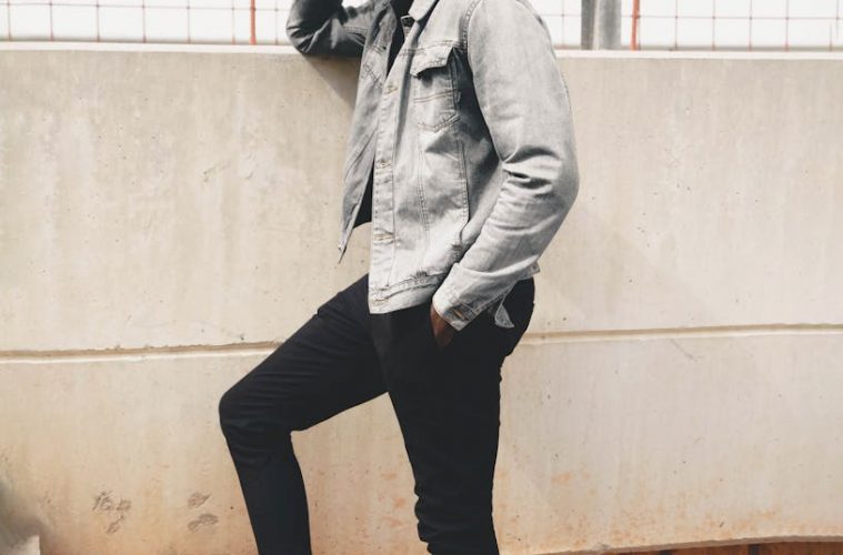 Model in a Gray Jacket and Black Pants Standing on the Stairs